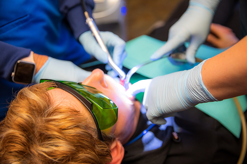 doctors working on a patients mouth